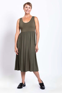 Front view of a woman wearing an olive green empire waist midi dress