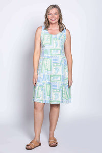 Front view of a woman wearing a sleeveless light green and blue patterned A-line dress