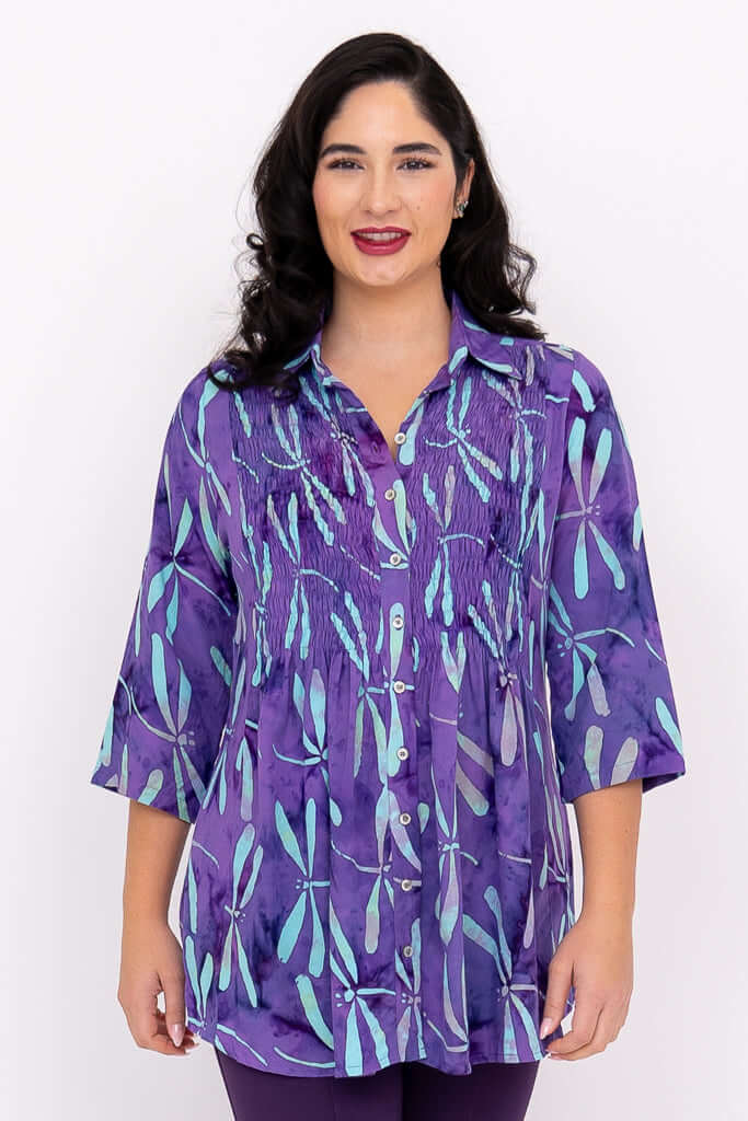 Front view of model wearing Cindy blouse in violet dragonfly print with 3/4 sleeves