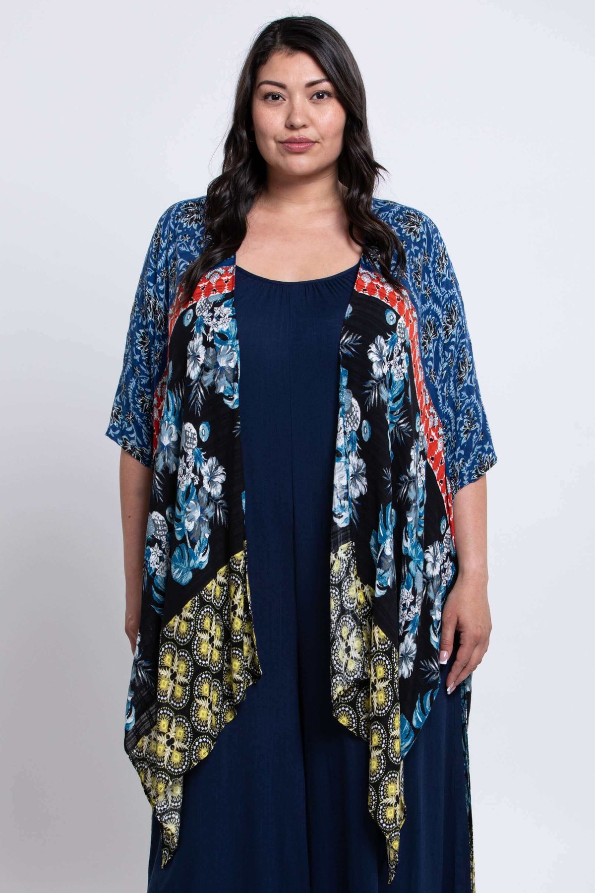 Front view of woman wearing a Darcy multicolor kimono wrap over a navy dress