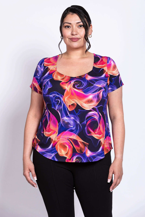 Front view of model wearing Ritzy Short Sleeve Top with vibrant swirl print