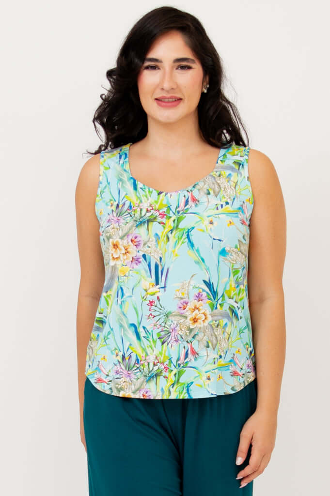 Front view of model wearing a floral print Ritzy Tank with teal wide-leg pants