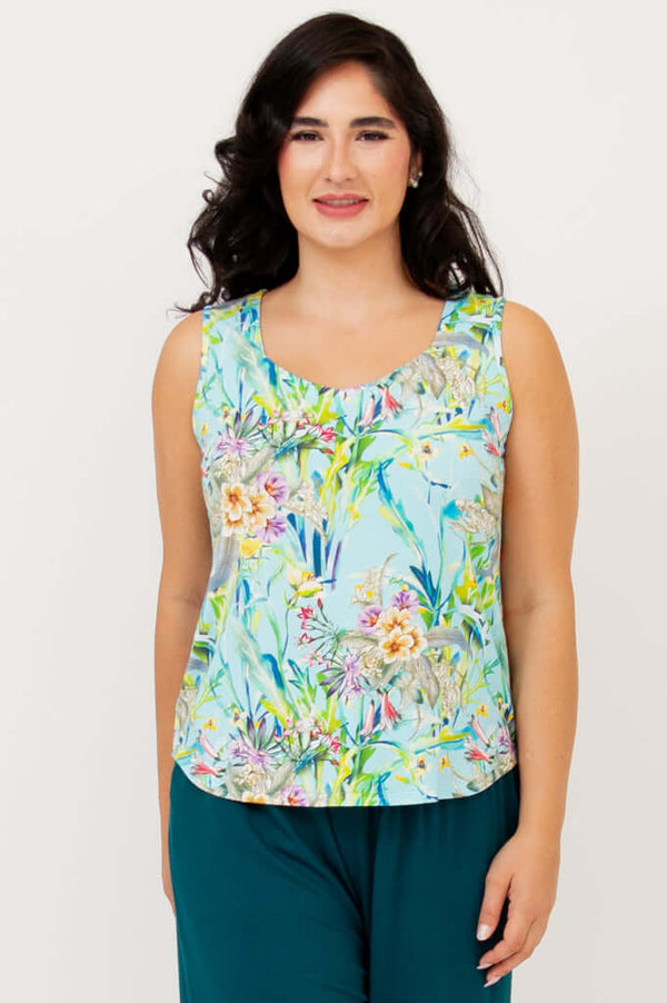 Front view of model wearing a floral print Ritzy Tank with teal wide-leg pants