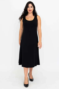 Front view of woman in a sleeveless black A-line dress with scoop neckline