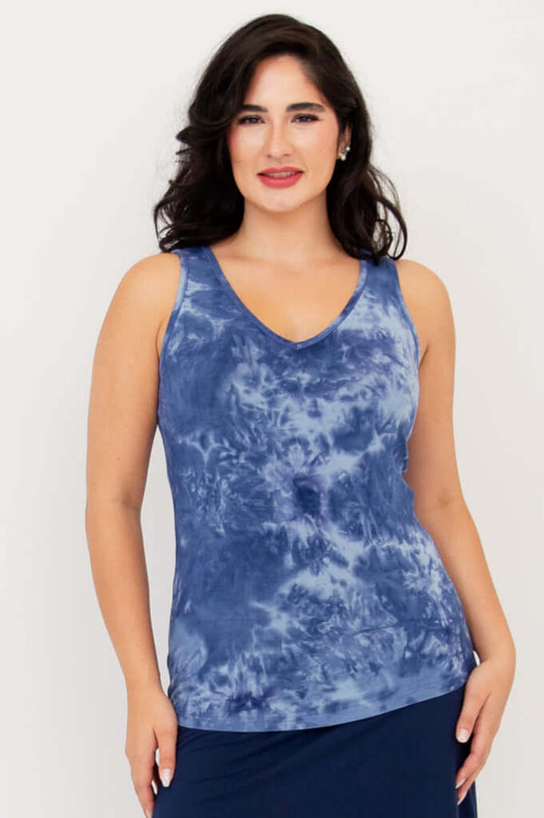 Front view of model wearing blue tie-dye reversible bamboo tank with V-neck
