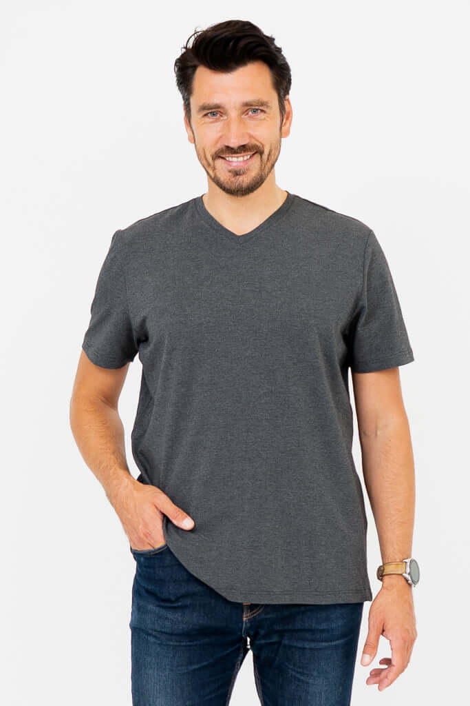 Front view of man wearing dark grey V-neck T-shirt with jeans