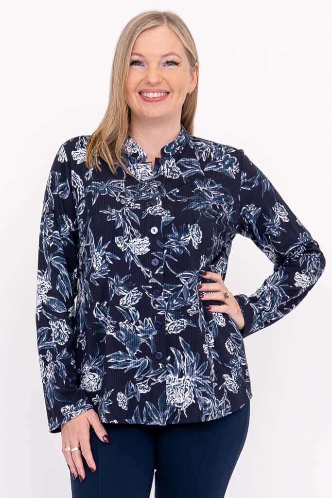 Front view of model wearing navy floral button-down top with mandarin collar