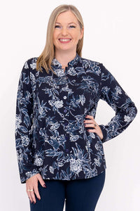 Front view of model wearing navy floral button-down top with mandarin collar