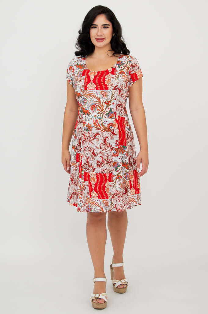 Woman modeling Anna dress with red paisley print, front view