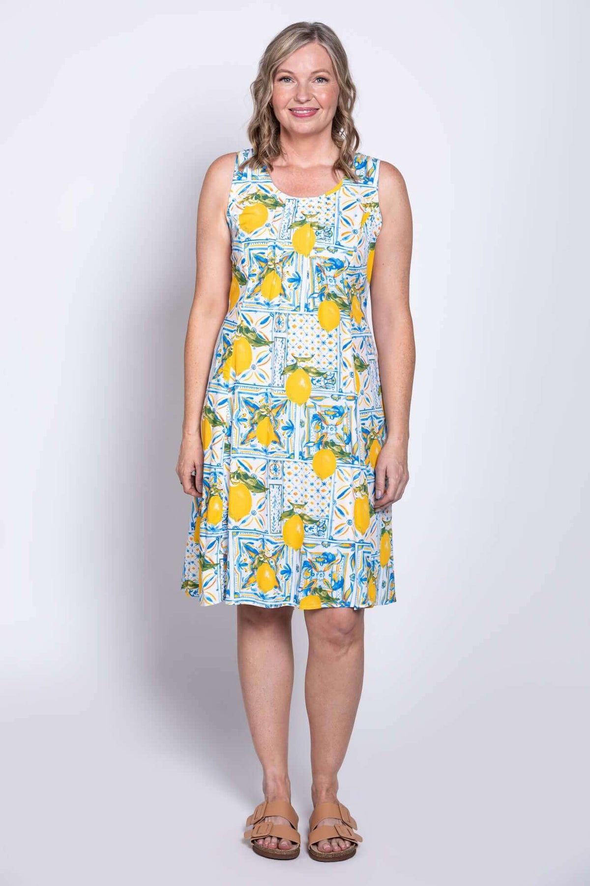 Model wearing sleeveless Arden dress, hands at sides, front view