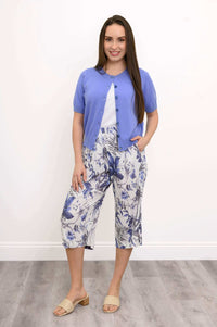 Model front full-body view in blue floral Bella Capri Pant and purple cardigan
