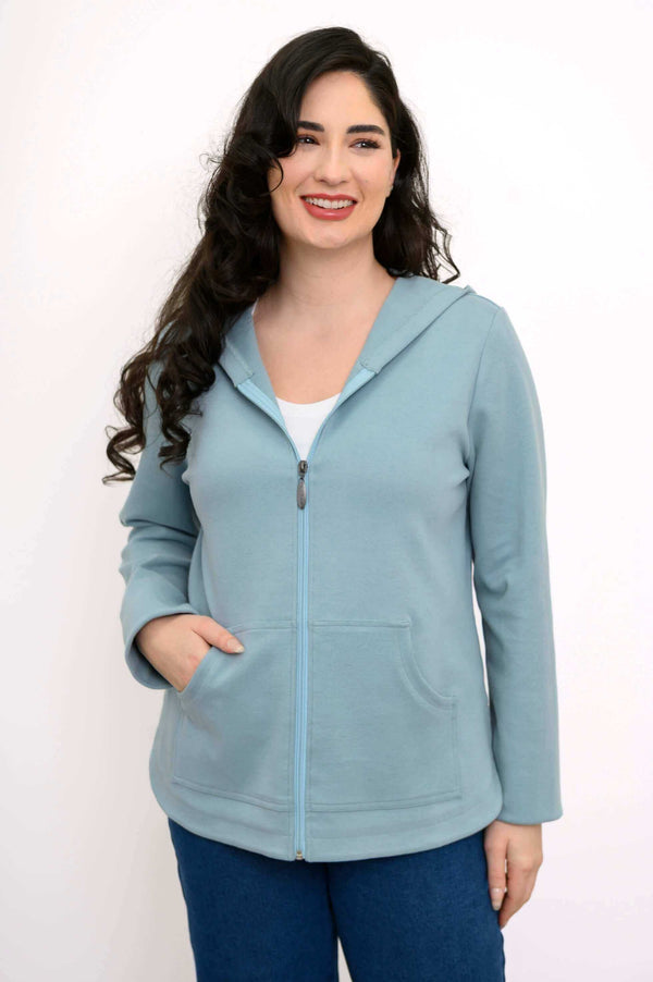 Front view of a woman wearing a light blue zip-up hoodie jacket with pockets