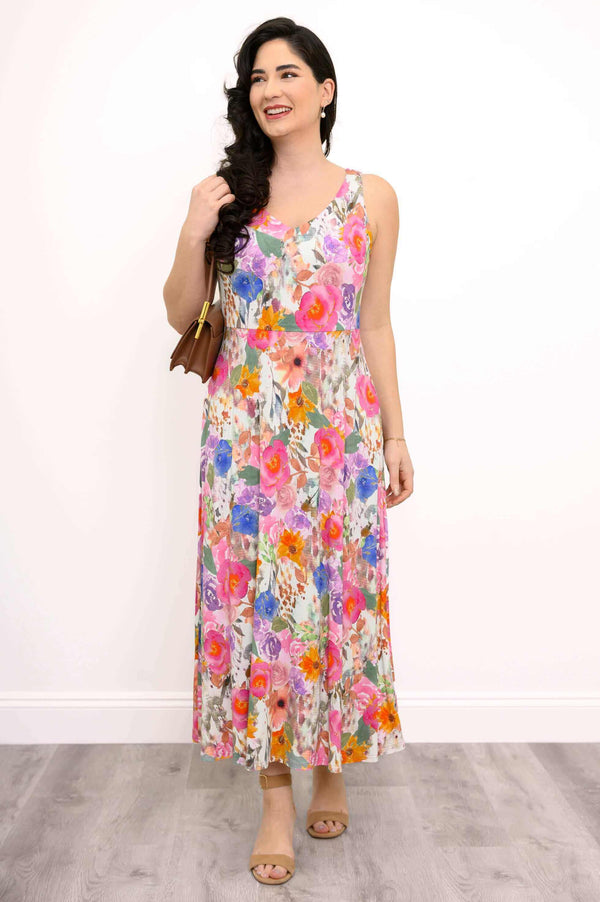 Front view of a woman wearing a colorful floral maxi dress with a U-neckline