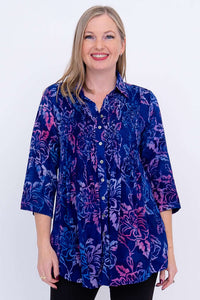 Woman wearing a blue and purple floral tunic with 3/4 sleeves, front view