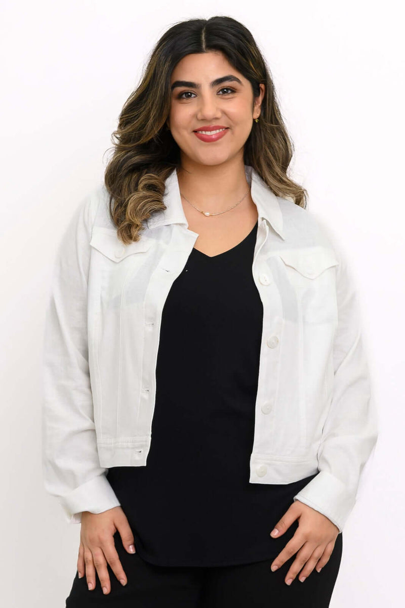 Front view of model wearing a white linen jean jacket over a black top