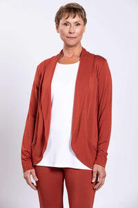 Front view of woman wearing rust-colored French Terry open front shawl collar jacket