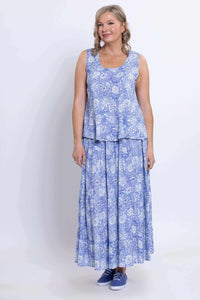 Woman in blue floral Ginny tank top and skirt, smiling, front view