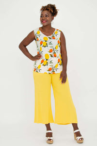Front view of a woman wearing the Hannah Citrus V-Neck Tank with vibrant lemon and orange print