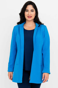 Front view of woman wearing a bright blue thigh-length coat with hood