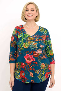 Woman wearing Jackie V Neck bamboo top with vibrant teal floral print, front view