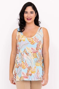 Front view of woman wearing light blue tank top with tropical leaf print
