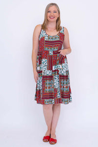 Front view of woman wearing sleeveless, tiered patchwork summer dress