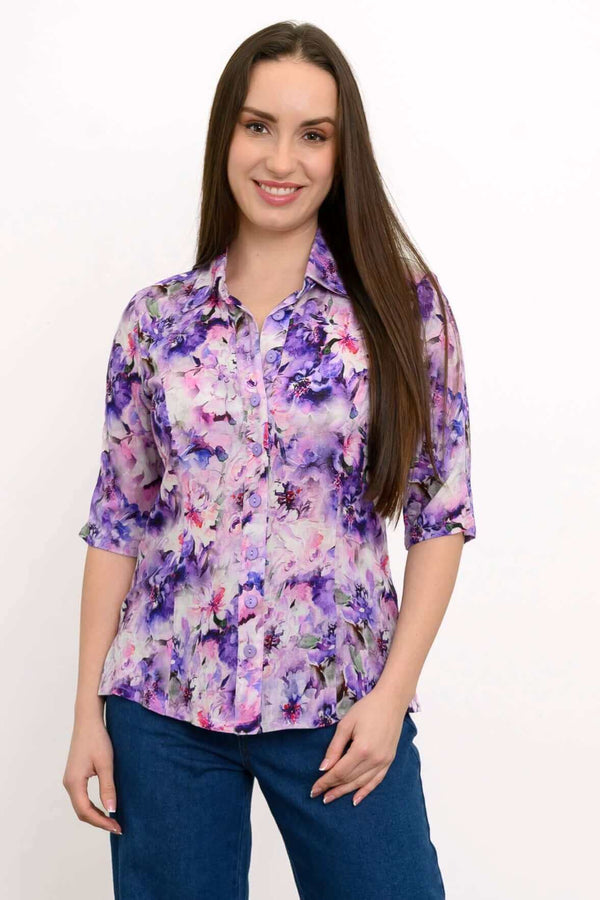 Front view of woman wearing a purple floral bamboo linen blouse with elbow-length sleeves