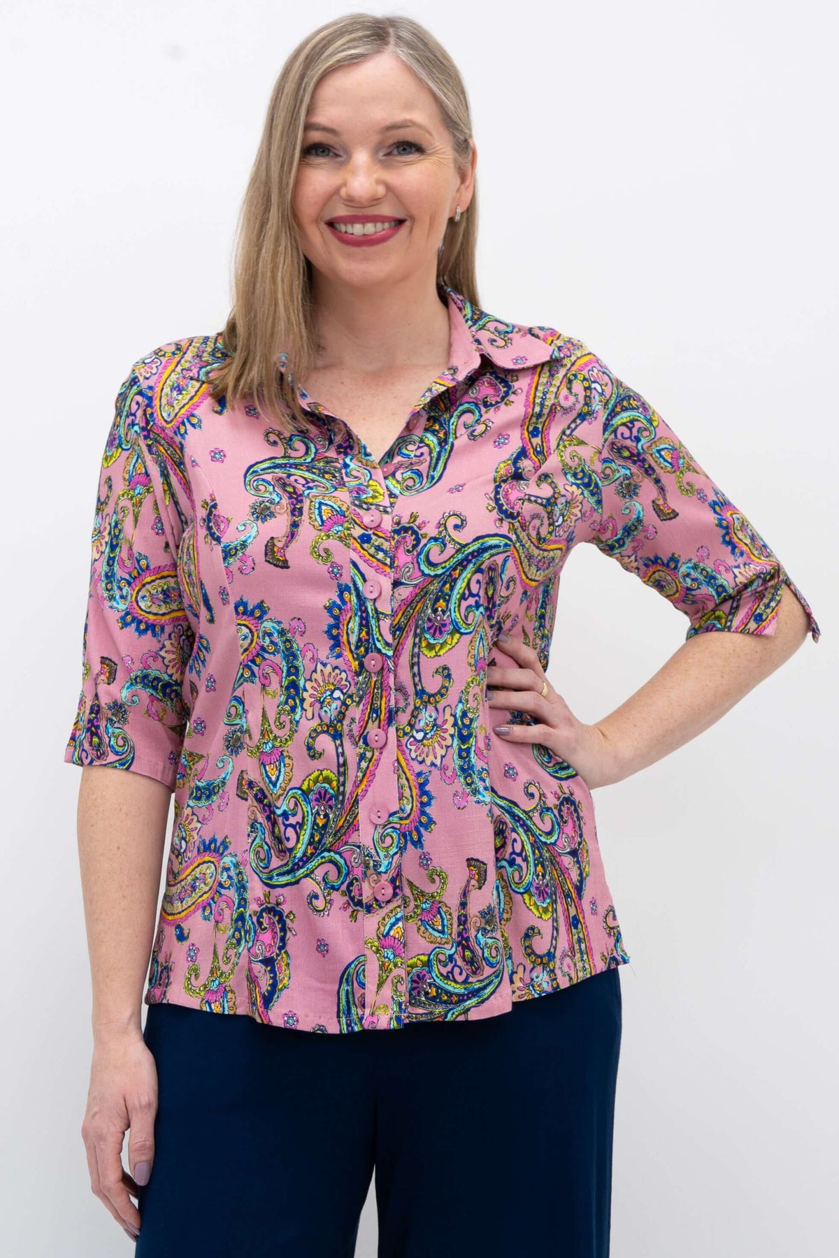 Woman wearing a tailored pink paisley bamboo-linen blouse with a small collar and elbow-length sleeves