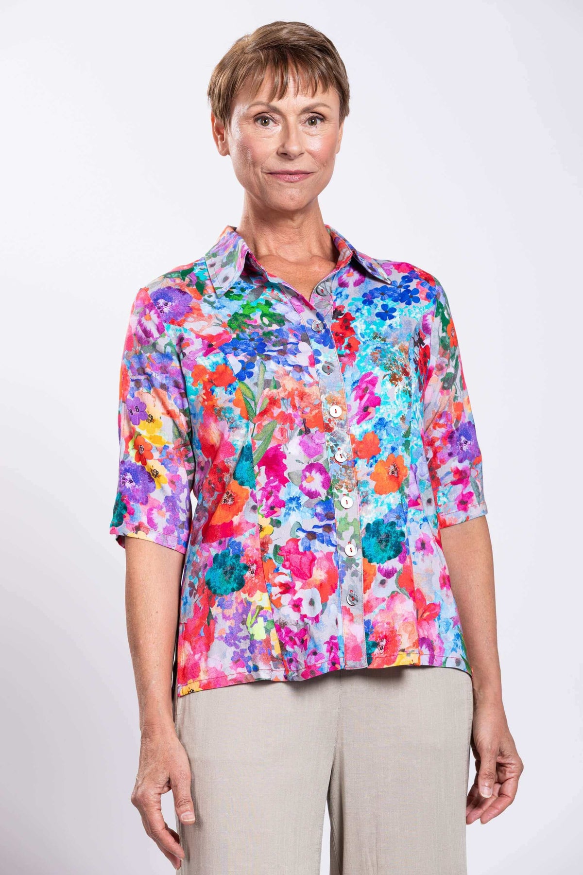 Front view of woman wearing a colorful floral bamboo linen blouse with shirt collar