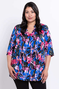 Front view of woman wearing a vibrant botanical print Margate blouse with pintucks