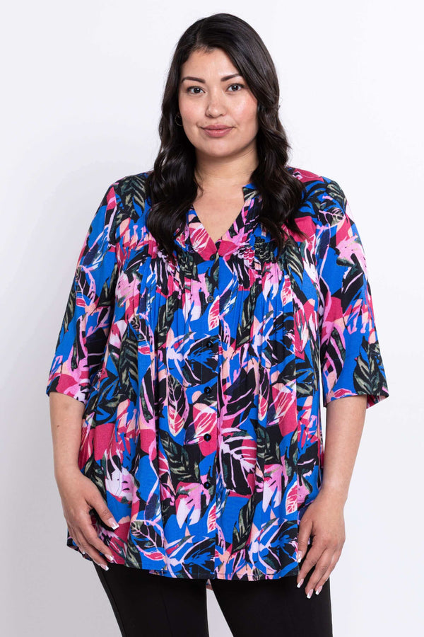 Front view of woman wearing a vibrant botanical print Margate blouse with pintucks