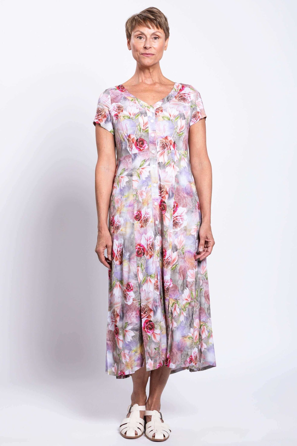 Front view of woman wearing a floral bamboo-linen blend dress with buttons