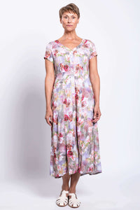 Front view of woman wearing a floral bamboo-linen blend dress with buttons