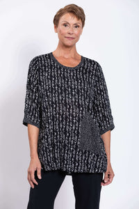 Front view of a model wearing a black and white Palace Blouse with abstract letter print