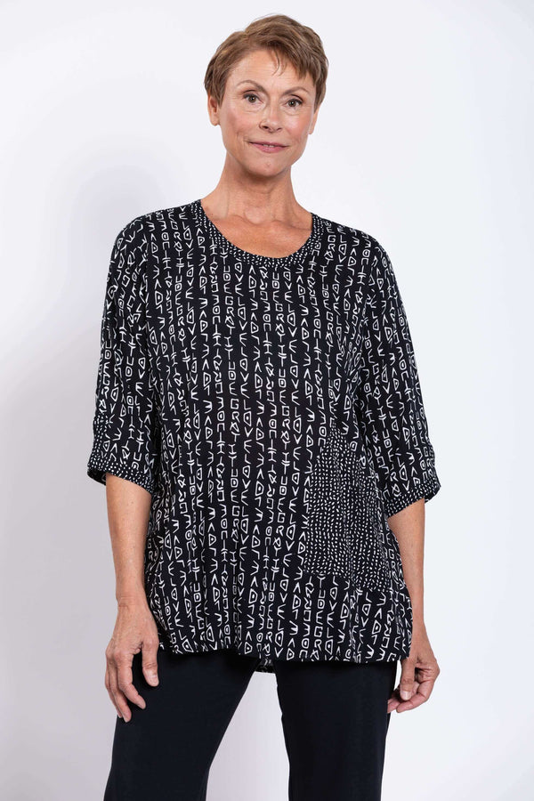 Front view of a model wearing a black and white Palace Blouse with abstract letter print