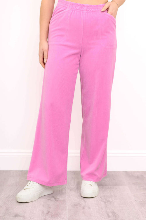 Front view of wide-leg pink corduroy pants with elastic waistband and pockets