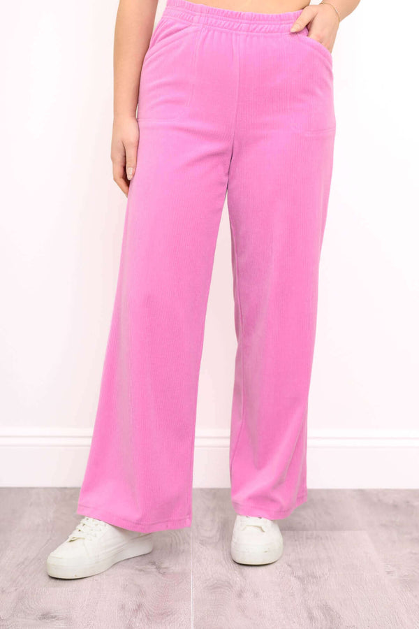 Front view of wide-leg pink corduroy pants with elastic waistband and pockets