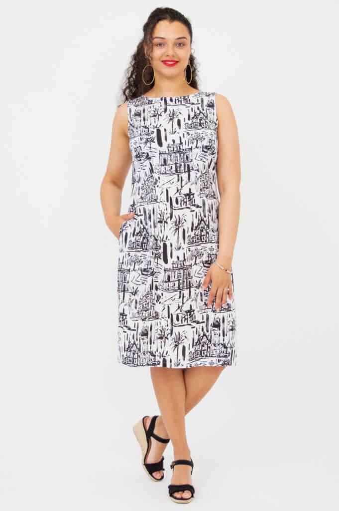 Front view of woman wearing Patricia sleeveless shift dress with black and white print