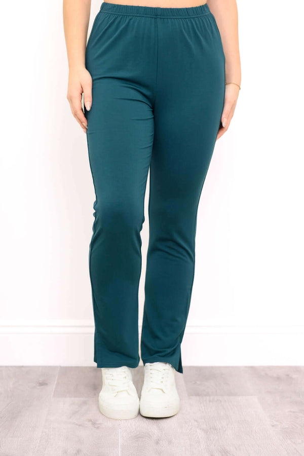 Front view of Sarina Pant in teal, styled with white sneakers