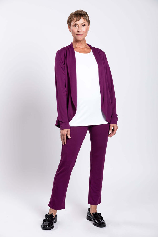 Front view of model wearing plum-colored slim bamboo pants and matching cardigan