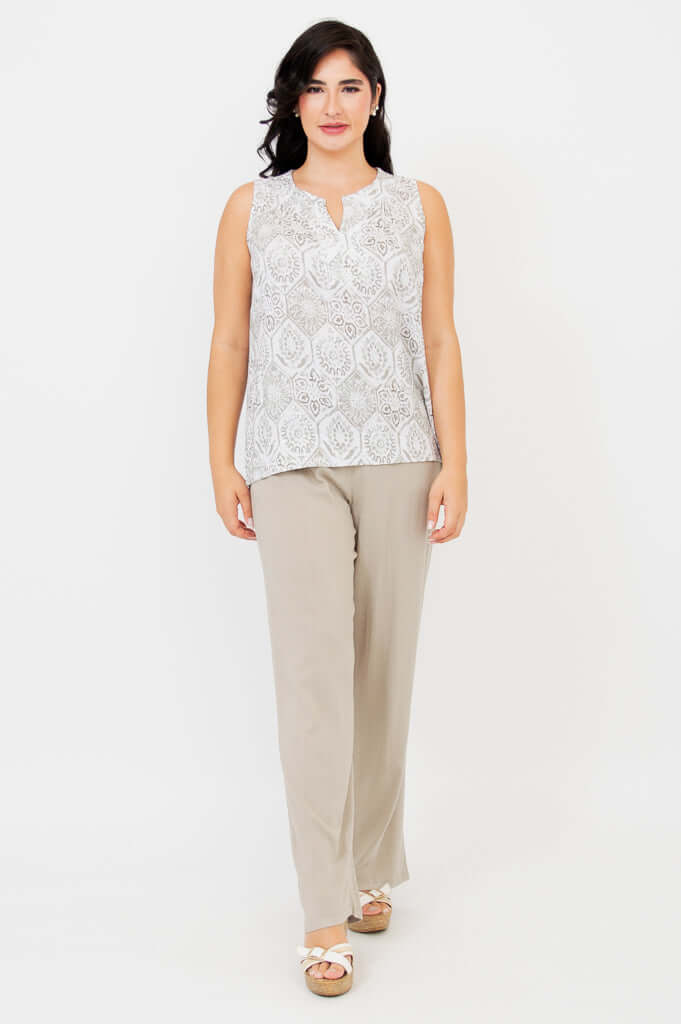 Front view of woman in Scarlette split neck tank and beige trousers