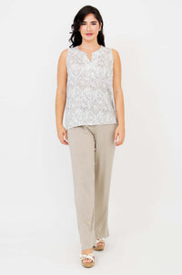 Front view of woman in Scarlette split neck tank and beige trousers