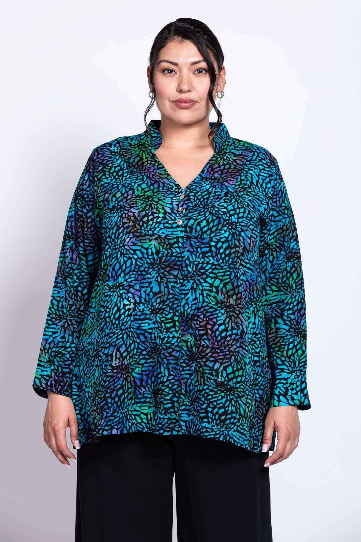 Front view of model wearing Shirley Blouse in blue and green printed rayon
