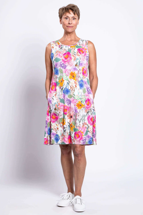Front view of woman wearing a sleeveless floral Willow Dress with pockets
