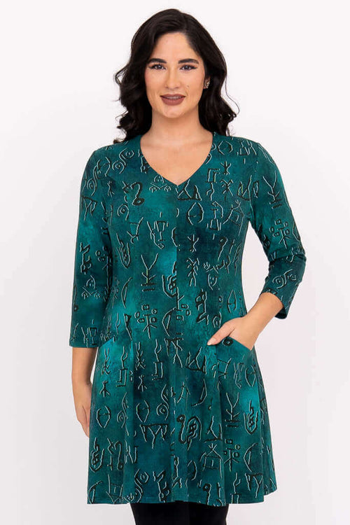 Front view of woman wearing teal abstract print Wilma Tunic dress with pockets