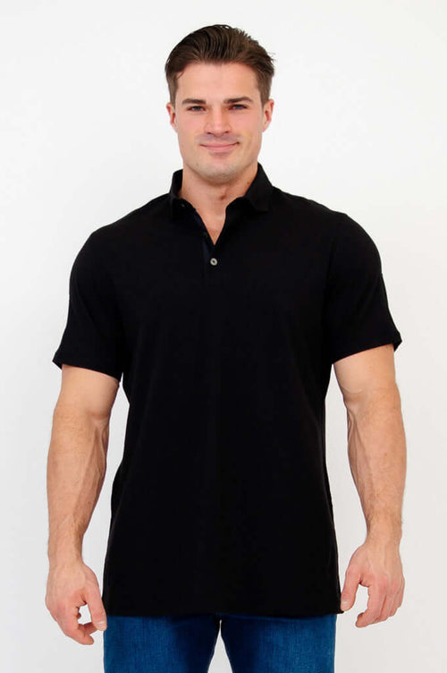Front view of man wearing a black short sleeve bamboo polo shirt