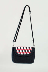 Front view of black crossbody bag with geometric embroidered flap