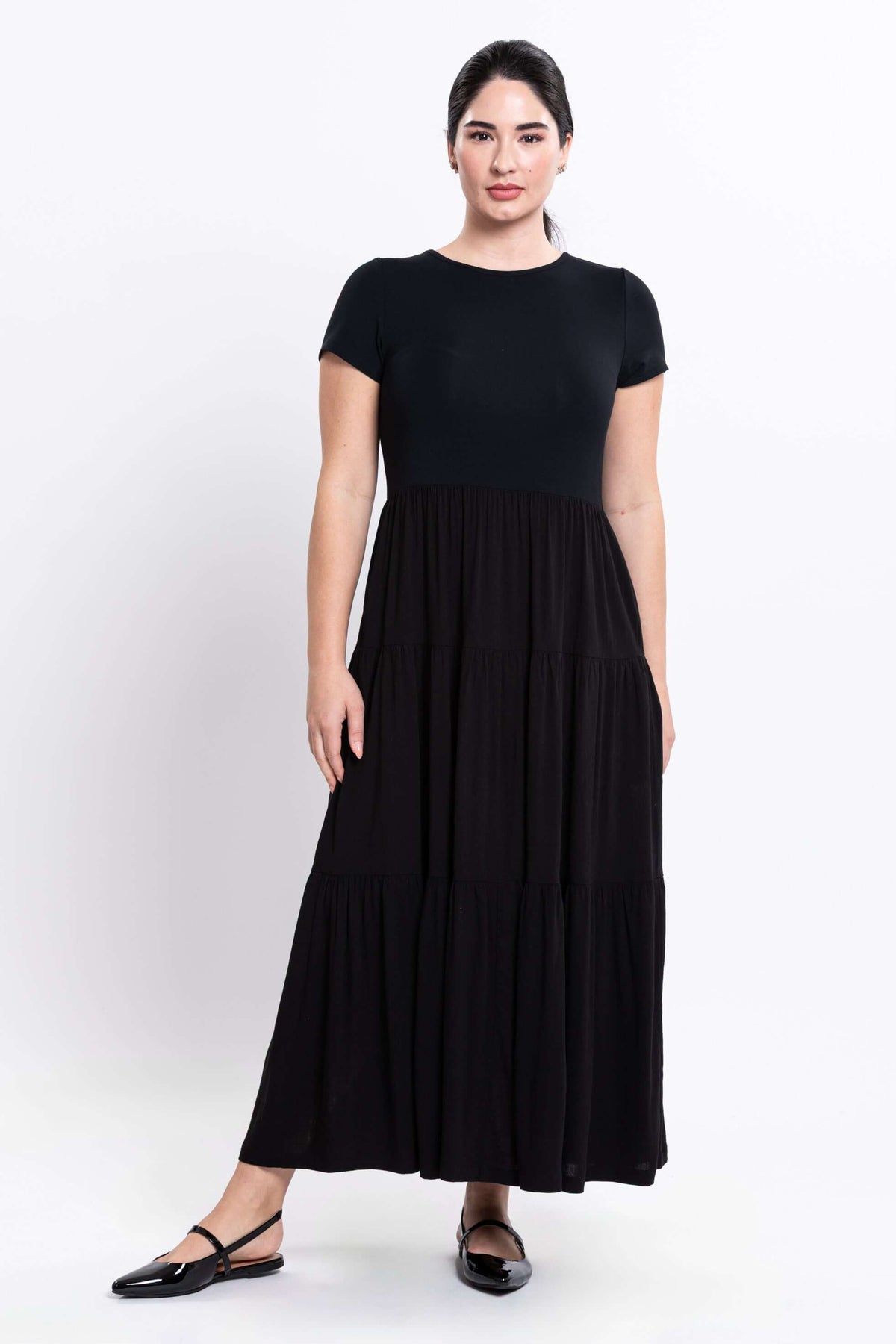 Front view of woman wearing a black short sleeve maxi dress
