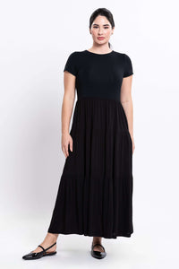 Front view of woman wearing a black short sleeve maxi dress