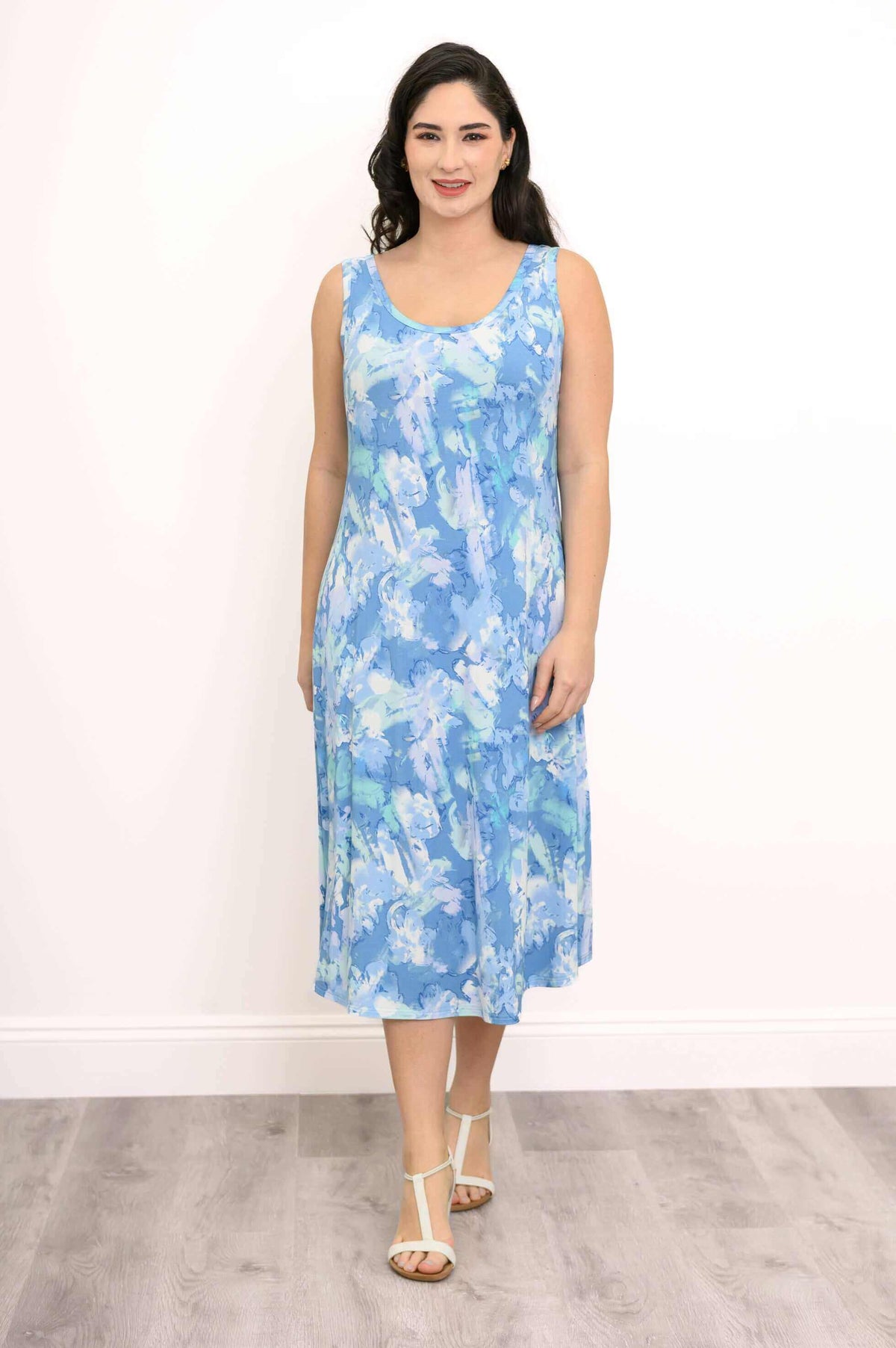 Woman in blue abstract print tank dress standing facing forward